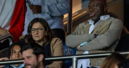 fayza lamari with her husband watching a game